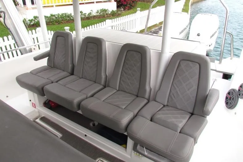 Slide: The Image of Four gray seats on 2018 Axopar 37 Sun-Top boat, near water and white fence. - 16