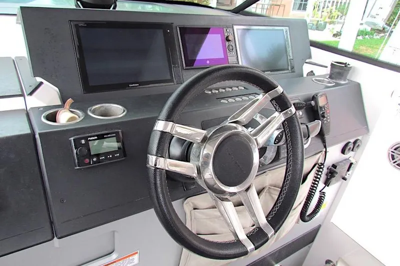 Slide: The Image of Steering console of 2018 Axopar 37 Sun-Top with modern navigation displays. - 22
