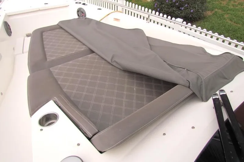 Slide: The Image of 2018 Axopar 37 Sun-Top boat with cushioned seating and protective cover. - 23