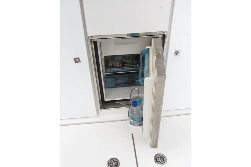 Slide: The Image of Open fridge on 2018 Axopar 37 Sun-Top boat, stocked with drinks. - 25