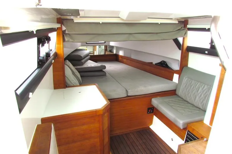 Slide: The Image of 2018 Axopar 37 Sun-Top cabin interior with wooden finish and comfortable seating. - 27