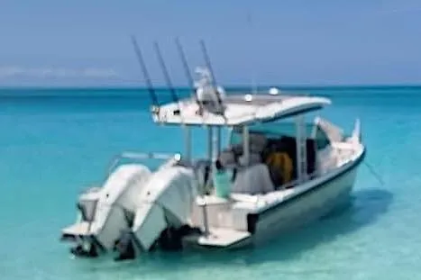 Slide: The Image of 2018 Axopar 37 Sun-Top boat in clear turquoise water, rear view. - 5
