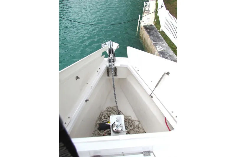 Slide: The Image of Anchor compartment of 2018 Axopar 37 Sun-Top boat by the water. - 7