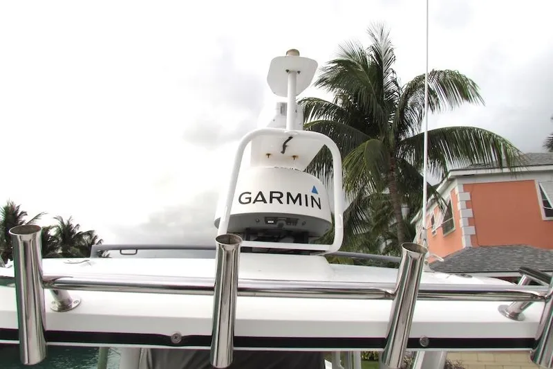 Slide: The Image of 2018 Axopar 37 Sun-Top boat with Garmin radar, palm trees in background. - 8
