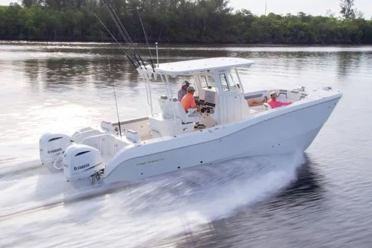 Slide: The Image of Manufacturer Provided Image: 2026 World Cat 295 CC cruising on water, featuring dual Yamaha engines. - 1