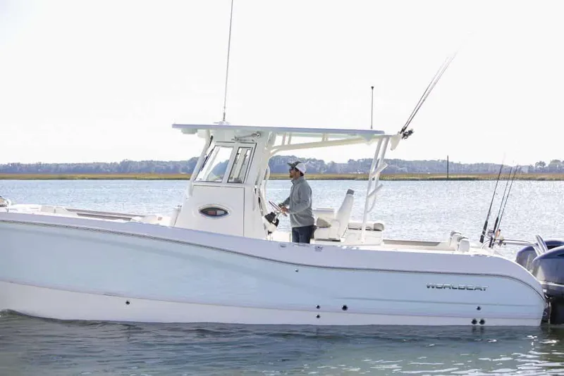 Slide: The Image of Manufacturer Provided Image: 2026 World Cat 295 CC boat on water, person steering, fishing rods visible. - 4