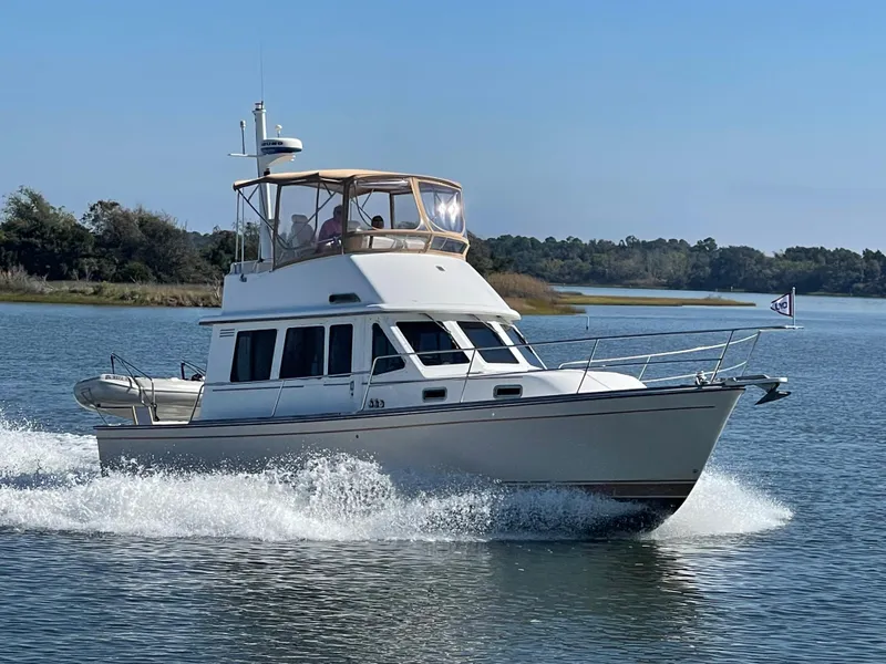 Slide: The Image of 2004 Sabre 36 Flybridge cruising on a calm lake. - 1