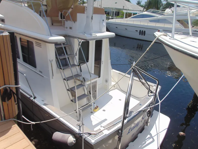Slide: The Image of 2004 Sabre 36 Flybridge yacht docked at marina. - 2