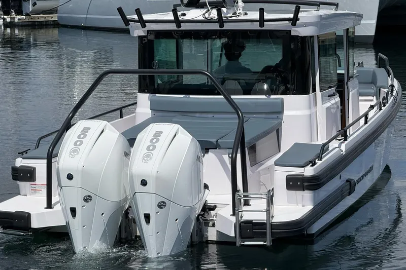 Slide: The Image of 2022 Axopar Brabus 28 Cabin with dual Mercury 200 engines on water. - 10