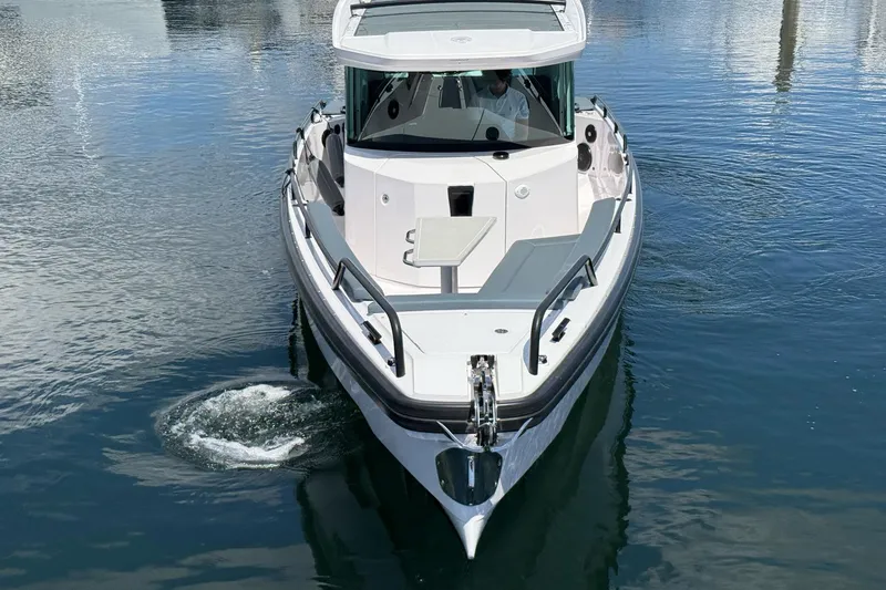 Slide: The Image of 2022 Axopar Brabus 28 Cabin boat on calm water, front view. - 20