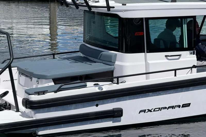 Slide: The Image of 2022 Axopar Brabus 28 Cabin boat on water, showcasing sleek design and modern features. - 23
