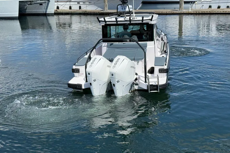 Slide: The Image of 2022 Axopar Brabus 28 Cabin boat with dual Mercury engines on water. - 24