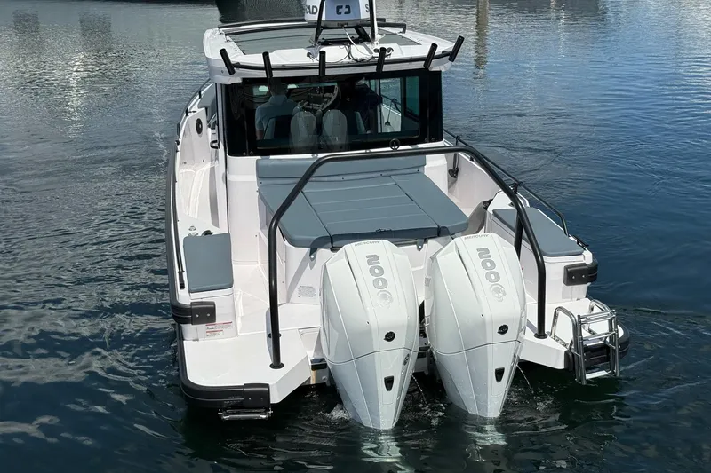 Slide: The Image of 2022 Axopar Brabus 28 Cabin boat with dual Mercury engines on water. - 28