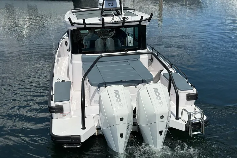 Slide: The Image of 2022 Axopar Brabus 28 Cabin boat with dual outboard engines on water. - 29