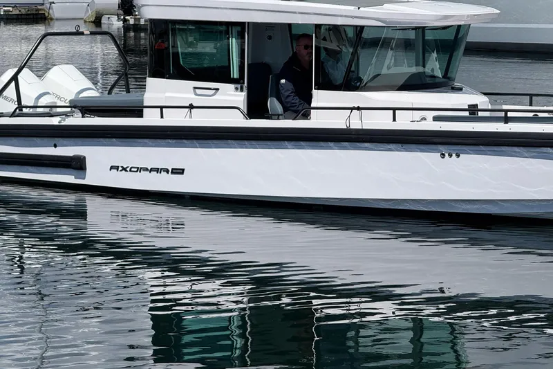 Slide: The Image of 2022 Axopar Brabus 28 Cabin boat on calm water, side view. - 3