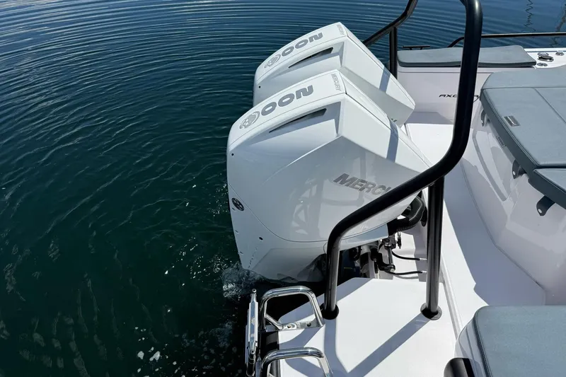Slide: The Image of 2022 Axopar Brabus 28 Cabin with twin Mercury outboard engines on calm water. - 31