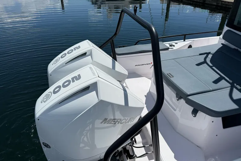Slide: The Image of 2022 Axopar Brabus 28 Cabin with twin Mercury outboard engines on calm water. - 32