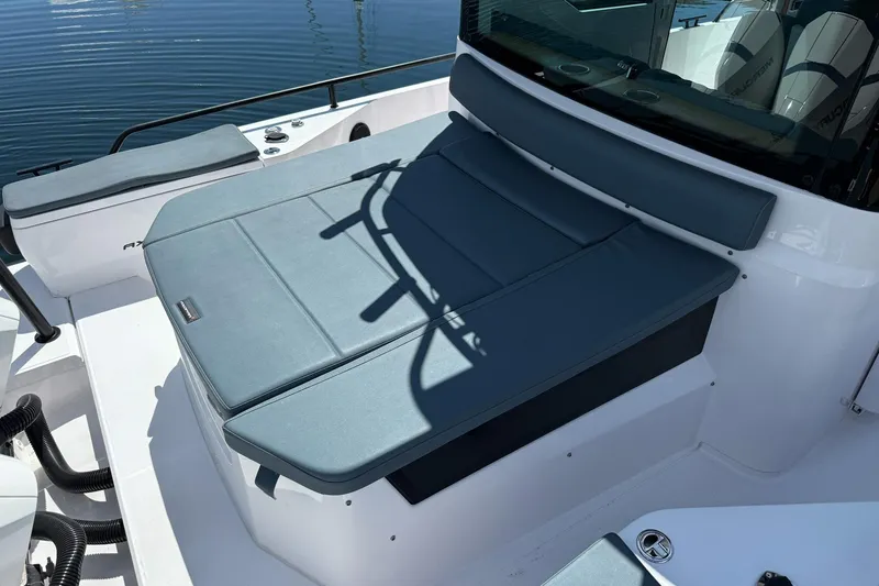 Slide: The Image of 2022 Axopar Brabus 28 Cabin boat interior with cushioned seating and sleek design. - 33