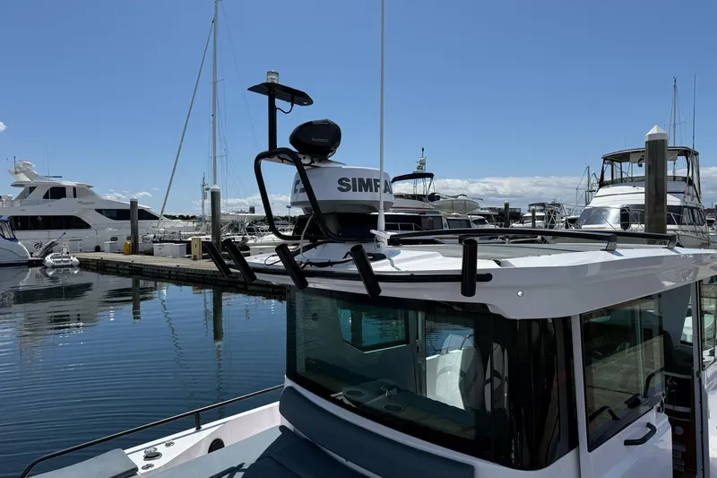 Slide: The Image of 2022 Axopar Brabus 28 Cabin docked at a marina under clear blue skies. - 35