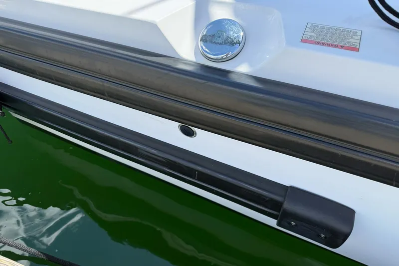 Slide: The Image of Close-up of 2022 Axopar Brabus 28 Cabin boat detail with water reflection. - 39