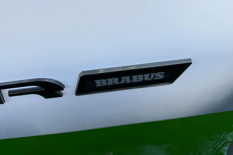 Slide: The Image of 2022 Axopar Brabus 28 Cabin logo on white and green surface. - 40