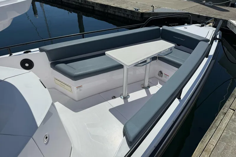 Slide: The Image of 2022 Axopar Brabus 28 Cabin boat with sleek seating and table arrangement. - 42