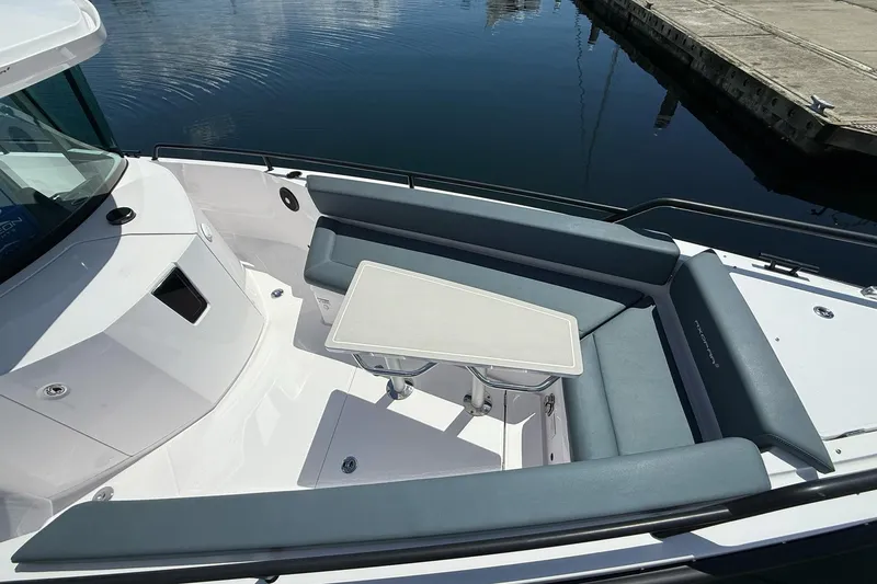 Slide: The Image of 2022 Axopar Brabus 28 Cabin boat with sleek seating and table arrangement. - 43