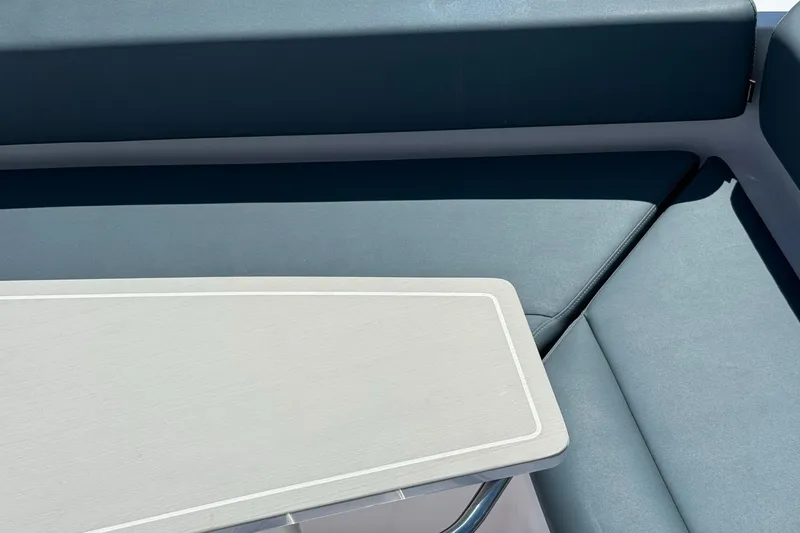 Slide: The Image of 2022 Axopar Brabus 28 Cabin interior with sleek seating and table design. - 44