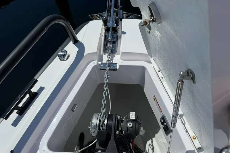 Slide: The Image of Anchor compartment of 2022 Axopar Brabus 28 Cabin boat with chain and winch. - 46