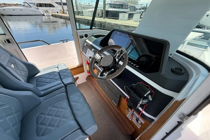 Slide: The Image of Interior of 2022 Axopar Brabus 28 Cabin boat with modern steering and seating. - 51
