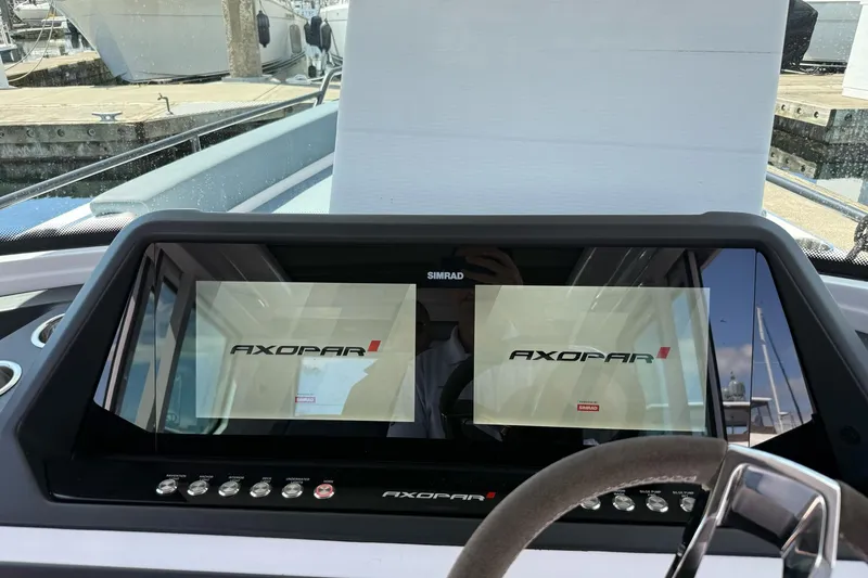 Slide: The Image of 2022 Axopar Brabus 28 Cabin dashboard with dual Simrad displays at marina. - 54