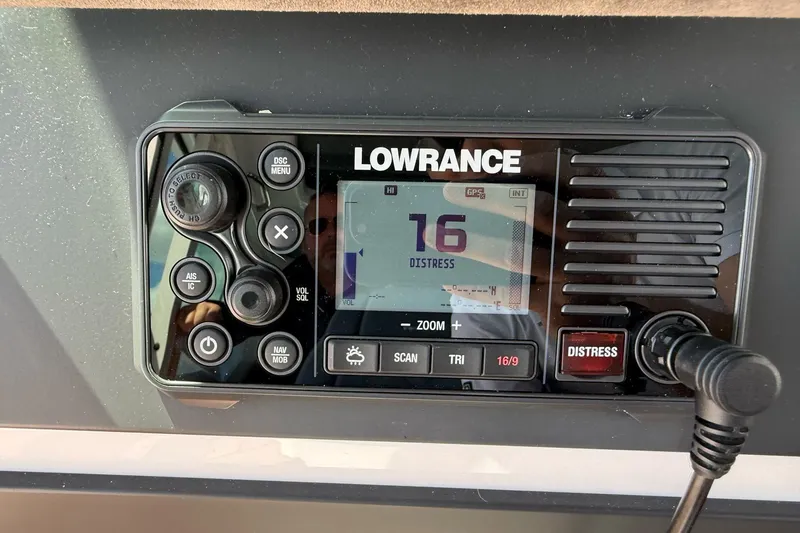 Slide: The Image of Lowrance marine radio on 2022 Axopar Brabus 28 Cabin, displaying channel 16 distress signal. - 56
