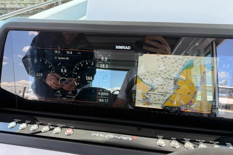 Slide: The Image of Dashboard of 2022 Axopar Brabus 28 Cabin with navigation and system display. - 59