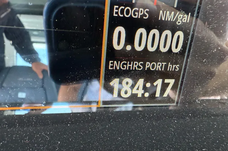 Slide: The Image of Display panel of 2022 Axopar Brabus 28 Cabin showing engine hours and fuel efficiency. - 61
