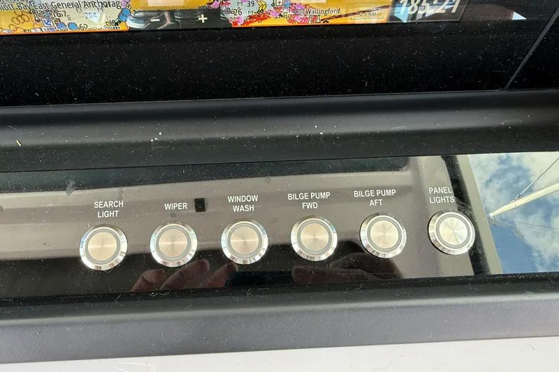 Slide: The Image of Control panel of 2022 Axopar Brabus 28 Cabin with labeled switches. - 63