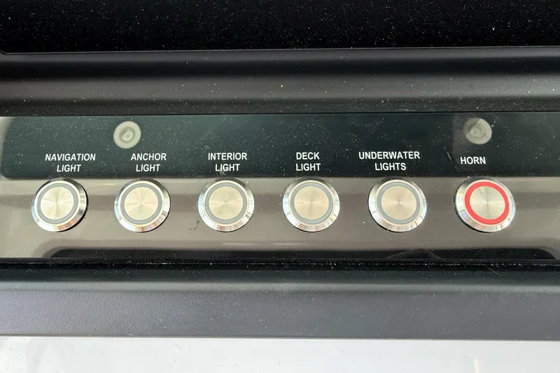 Slide: The Image of Control panel of 2022 Axopar Brabus 28 Cabin with light and horn switches. - 64