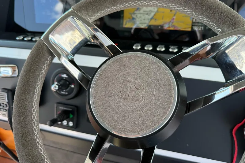 Slide: The Image of Steering wheel of 2022 Axopar Brabus 28 Cabin boat with navigation display. - 65