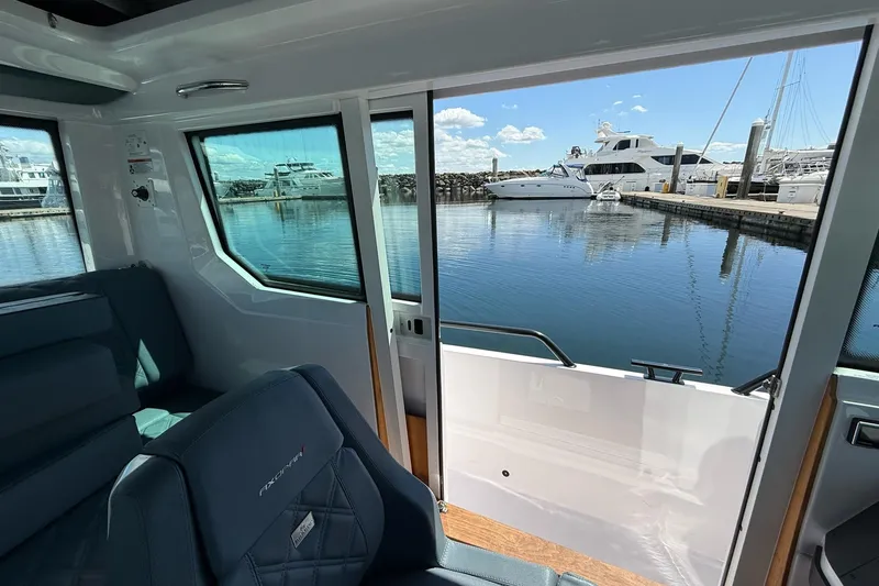 Slide: The Image of Interior view of 2022 Axopar Brabus 28 Cabin overlooking marina with yachts. - 70