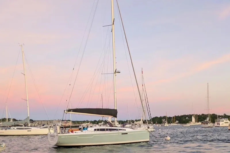 The Image of 2019 Dehler 34 sailboat anchored at sunset with other boats in the background. - 0