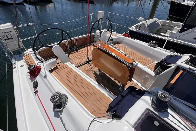 Slide: The Image of 2019 Dehler 34 sailboat cockpit with dual steering wheels and teak decking. - 11