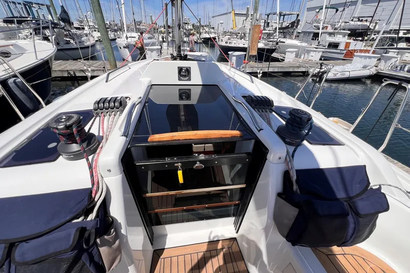 Slide: The Image of 2019 Dehler 34 sailboat cockpit with winches and marina view. - 18