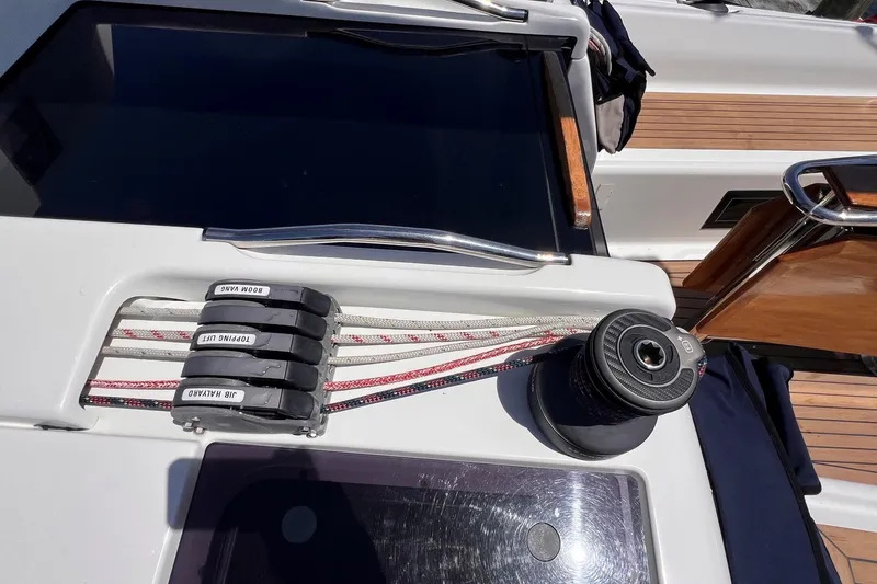 Slide: The Image of Deck of 2019 Dehler 34 sailboat with winch and labeled rope clutches. - 21