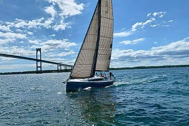 Slide: The Image of Sailboat Dehler 34c 2019 cruising under a large bridge on a sunny day. - 3