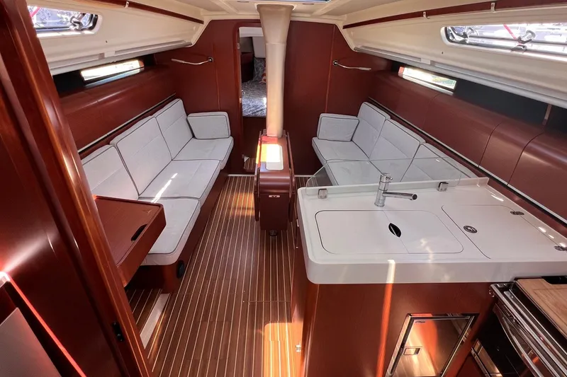 Slide: The Image of Interior of 2019 Dehler 34 yacht with modern kitchen and seating area. - 33
