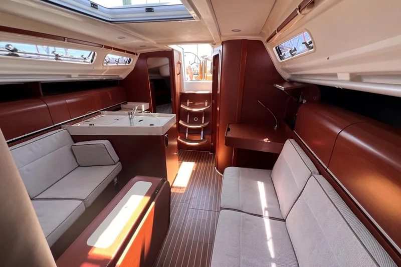 Slide: The Image of Interior of 2019 Dehler 34 yacht with modern wood finish and comfortable seating. - 34