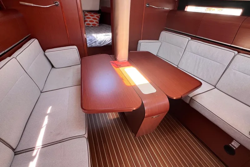 Slide: The Image of Interior of 2019 Dehler 34 yacht with elegant wood finish and cozy seating area. - 37