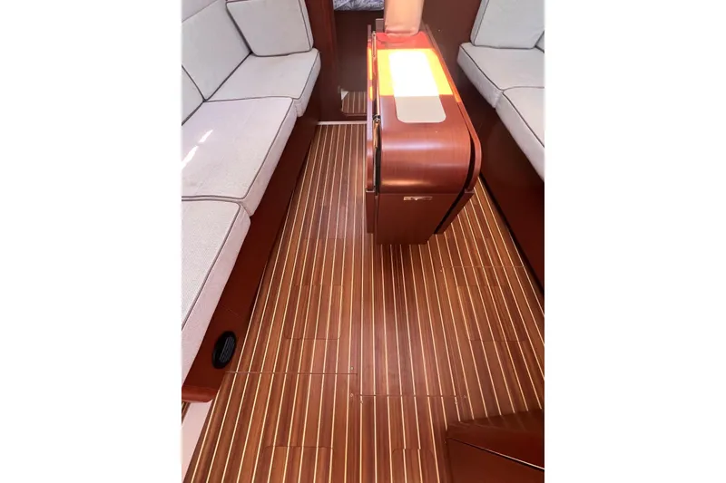 Slide: The Image of 2019 Dehler 34 interior with wooden flooring and cushioned seating. - 38