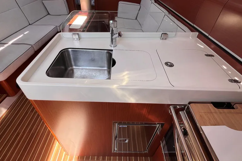 Slide: The Image of 2019 Dehler 34 yacht interior kitchen with sink and modern cabinetry. - 41