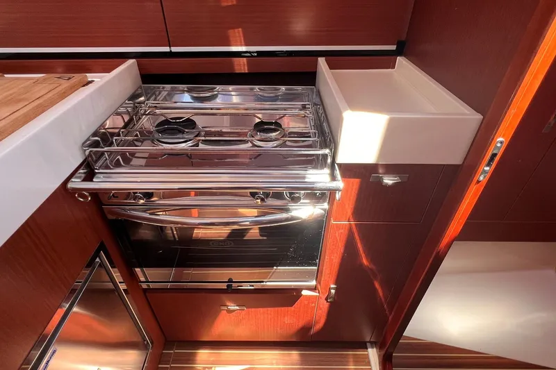 Slide: The Image of Modern kitchen area in a 2019 Dehler 34 yacht with stove and sink. - 42