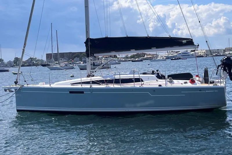 Slide: The Image of 2019 Dehler 34 sailboat with black sail, anchored in a marina. - 55